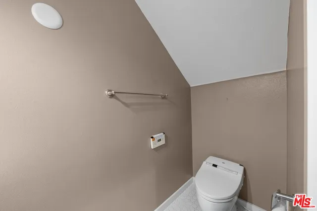 a white toilet sitting next to a bathroom sink