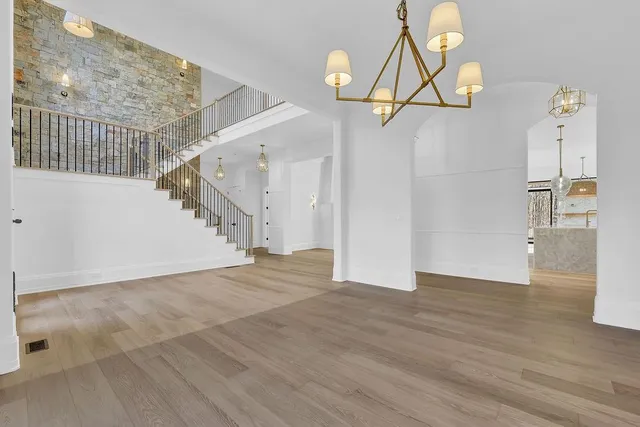 a bathroom with a granite countertop sink a toilet and shower