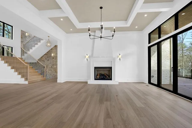 a view of an empty room with a fireplace and a window