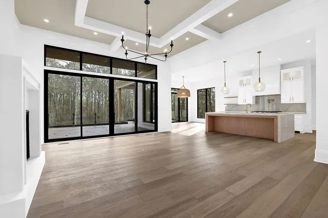 a backyard of a house with large trees and wooden fence