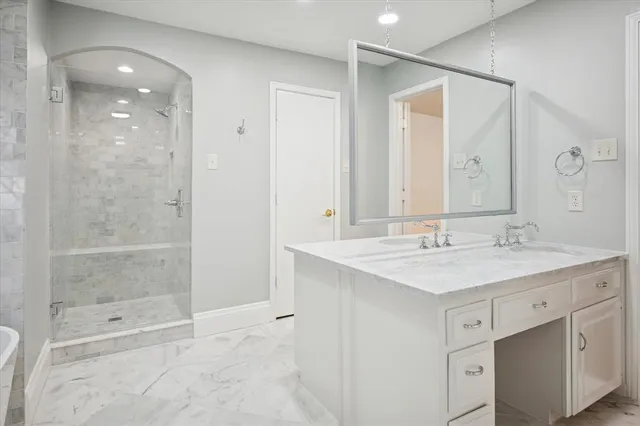 a bathroom with a shower sink and mirror