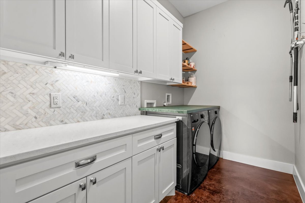 913 Stobaugh Street, Unit B Austin, TX 78757 - Photo 21 of 40 Functional laundry space featuring convenient storage solutions and modern appliances.