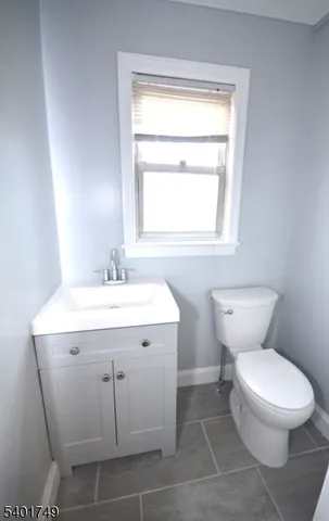 a bathroom with a sink toilet and a mirror