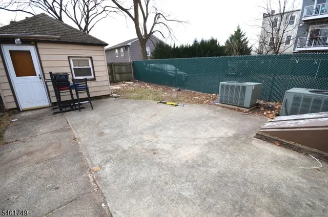 a backyard of a house with lake view and wooden fence