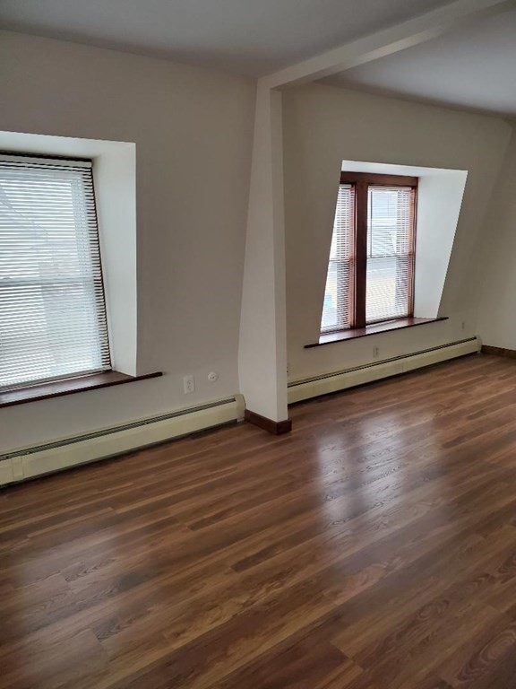 0 Coggeshall Street, Unit 1 Fall River, MA 02721 - Photo 2 of 11 a view of an empty room with wooden floor and a window