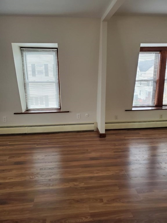 0 Coggeshall Street, Unit 1 Fall River, MA 02721 - Photo 4 of 11 a view of empty room with window and wooden floor