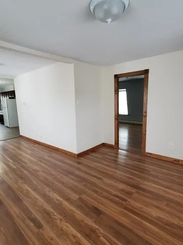 a view of an empty room and wooden floor