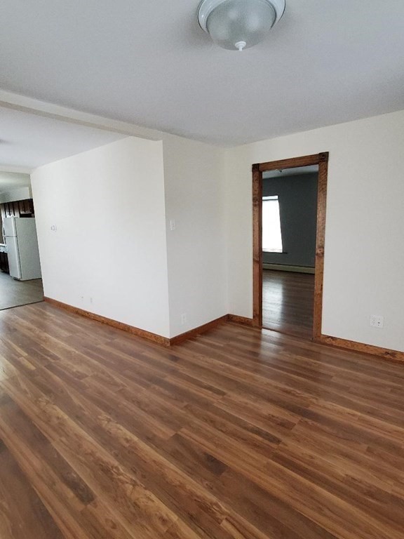 0 Coggeshall Street, Unit 1 Fall River, MA 02721 - Photo 7 of 11 a view of an empty room and wooden floor