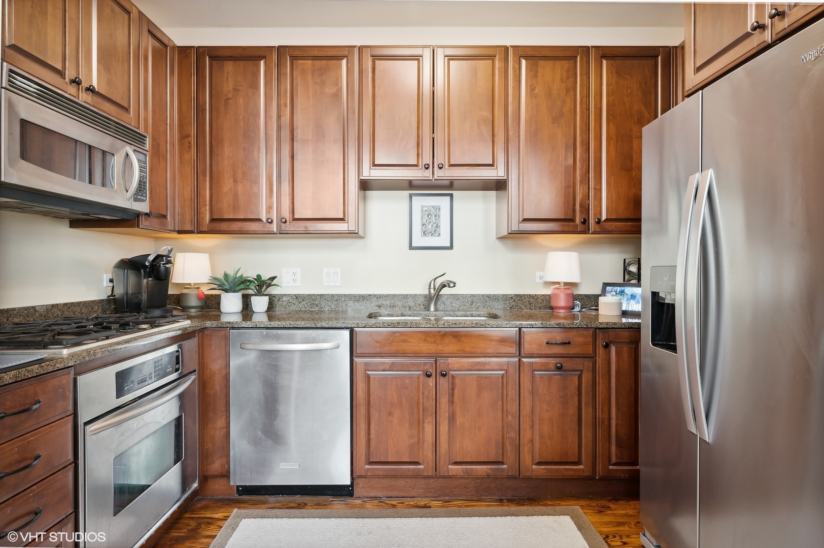 1041 Ridge Road, Unit 217 Wilmette, IL 60091 - Photo 6 of 19 a kitchen with stainless steel appliances granite countertop a refrigerator stove and sink