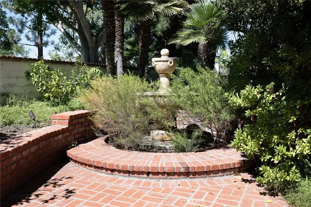 a view of a garden with large tree