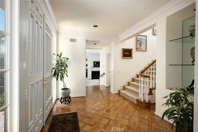 a view of an entryway with wooden floor and a livingroom view