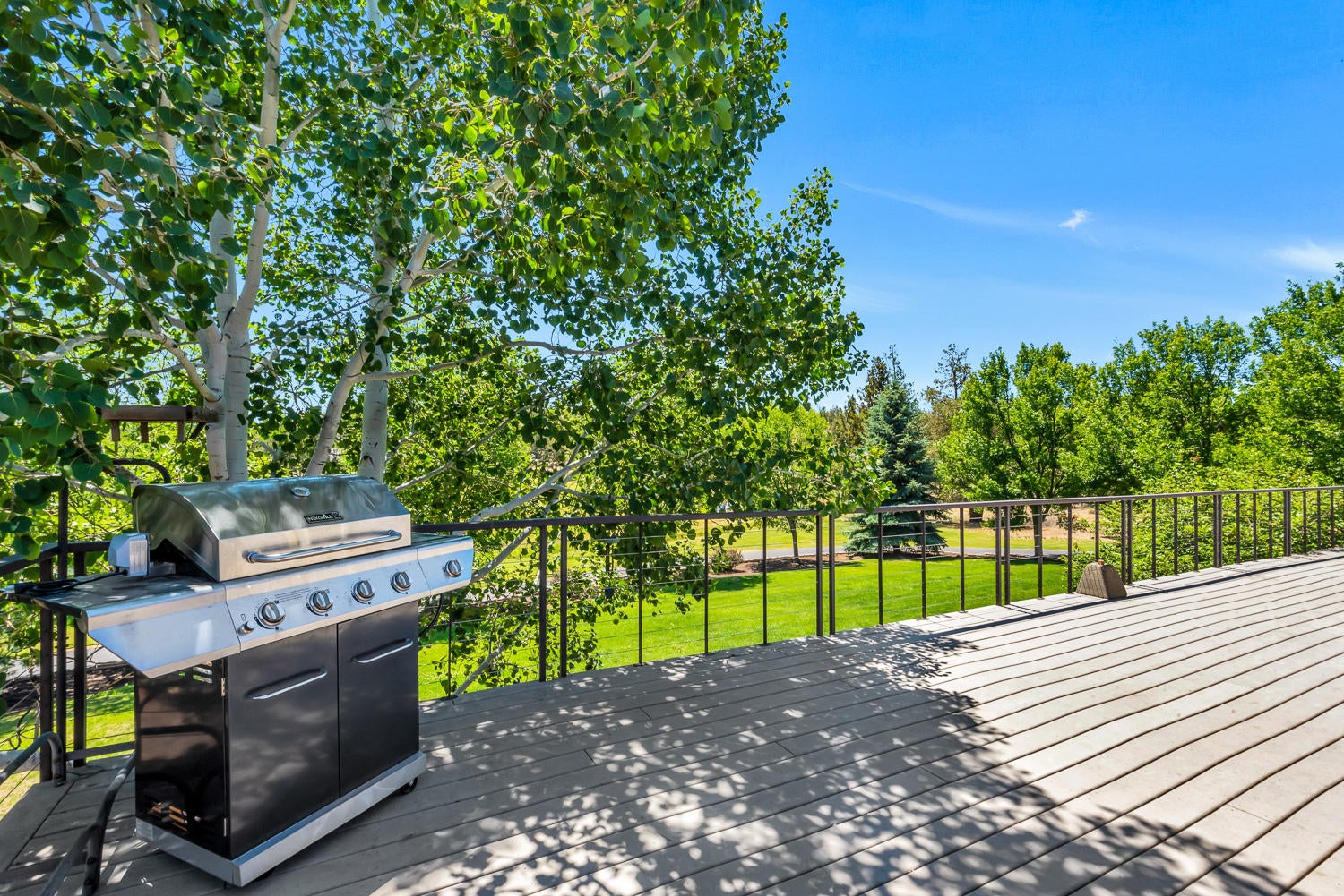 19310 Dayton Road Bend, OR 97703 - Photo 20 of 40 Plan on spending most of your time on this south-facing, wrap-around deck offering sweeping views of surrounding pastures.