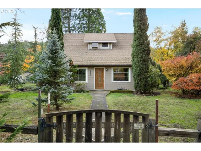 a front view of house with yard and trees