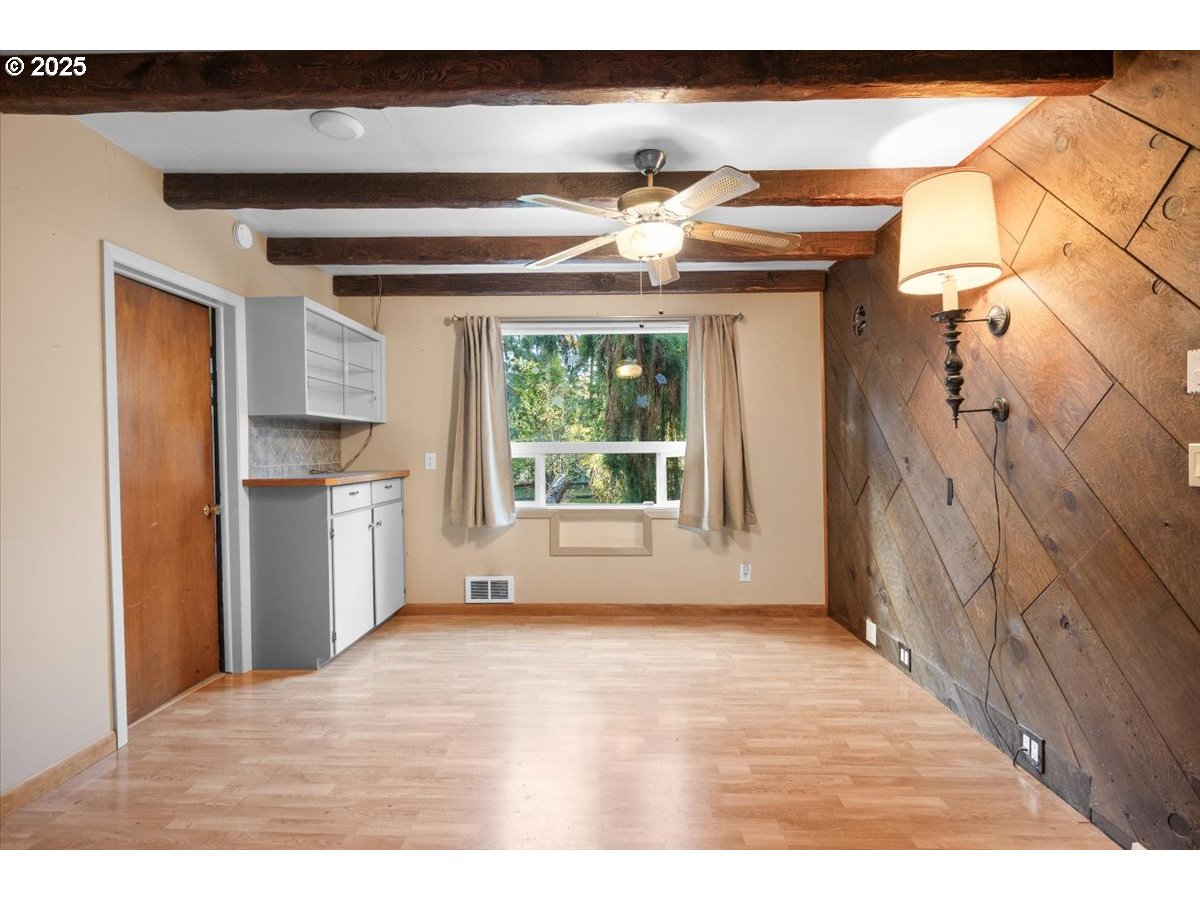 939 Buckhorn Road Roseburg, OR 97470 - Photo 6 of 35 a view of empty room with wooden floor and fan