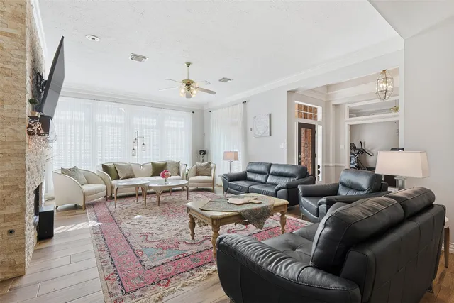 a living room with furniture a fireplace and a flat screen tv