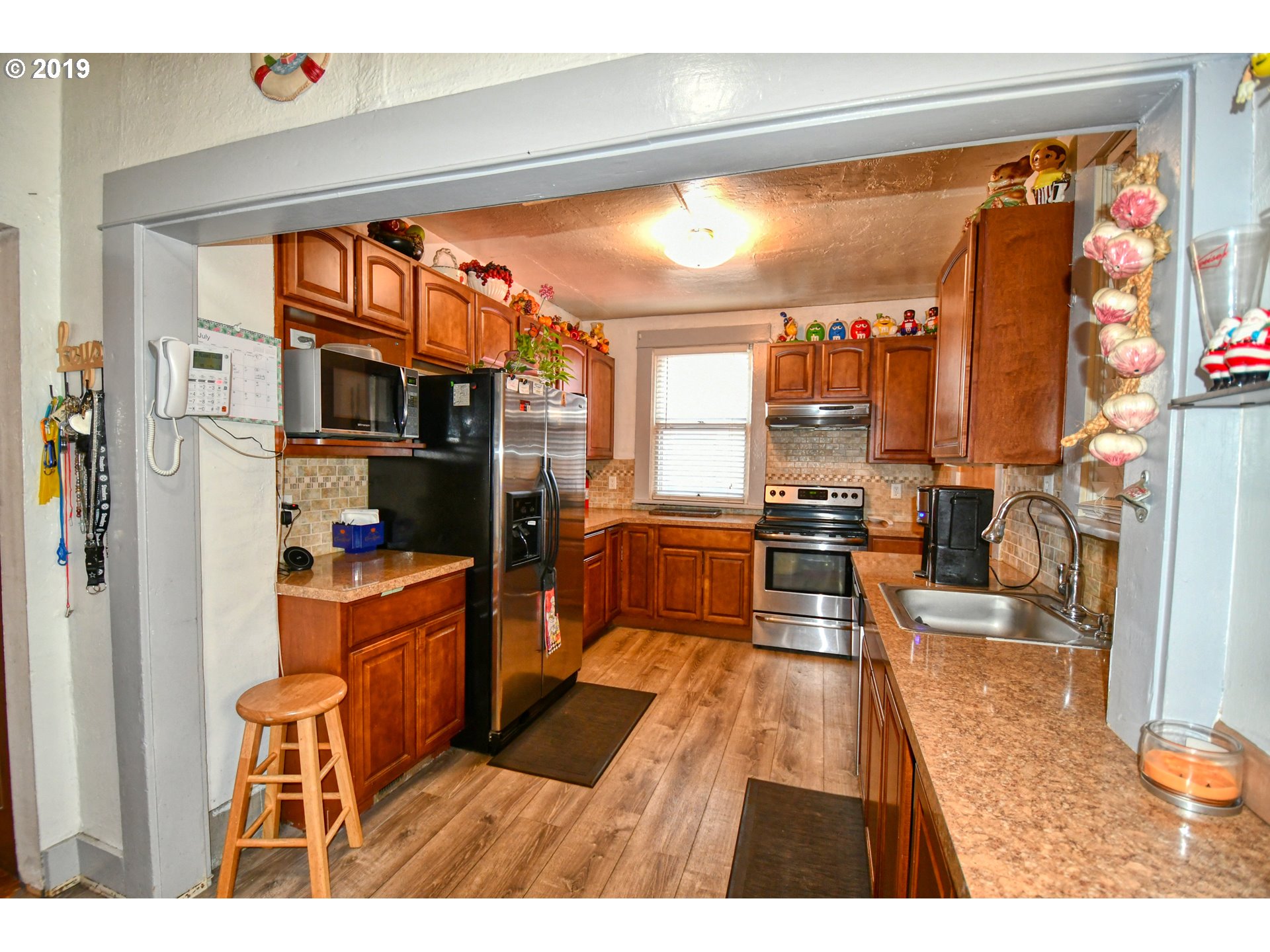 324 Southwest 2nd Street Pendleton, OR 97801 - Photo 11 of 32 a living room with stainless steel appliances furniture a rug and a view of kitchen