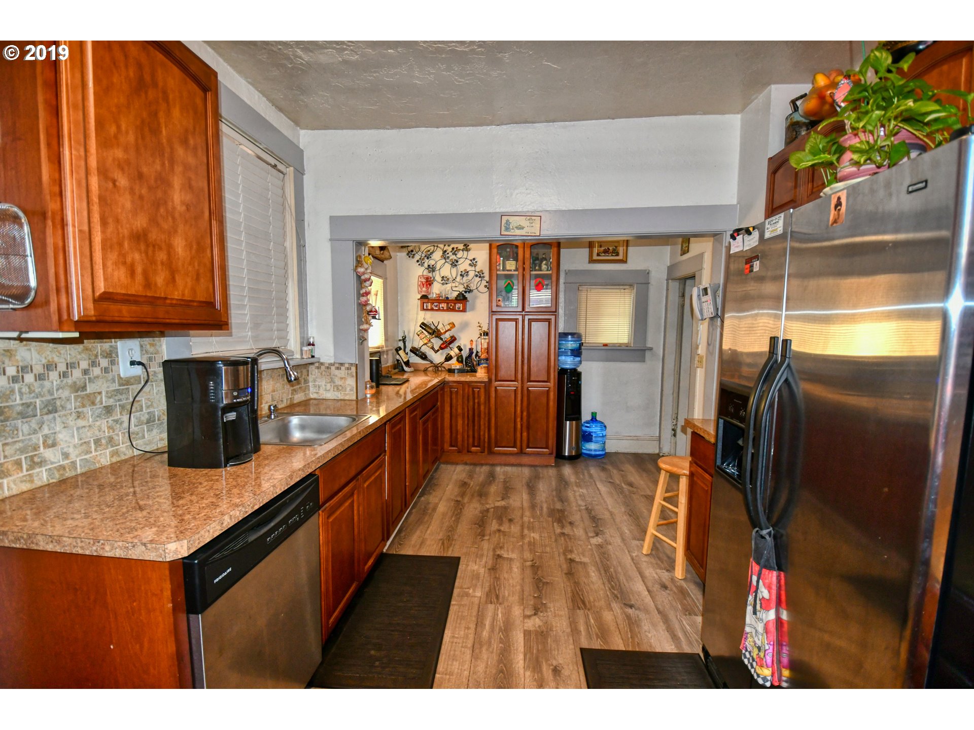 324 Southwest 2nd Street Pendleton, OR 97801 - Photo 14 of 32 a kitchen with stainless steel appliances granite countertop a refrigerator a sink dishwasher and wooden cabinets
