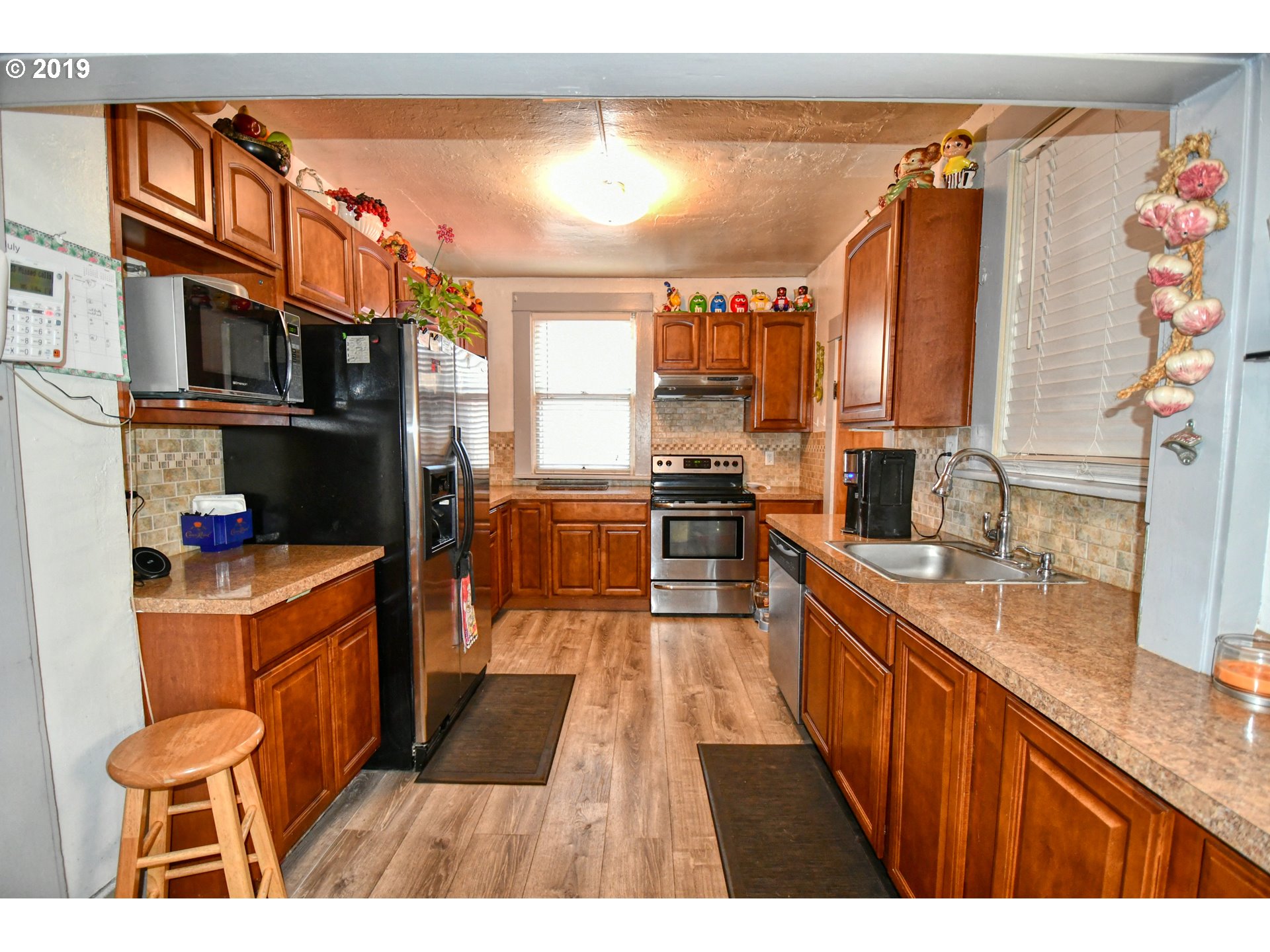 324 Southwest 2nd Street Pendleton, OR 97801 - Photo 15 of 32 a kitchen with stainless steel appliances a sink and a refrigerator