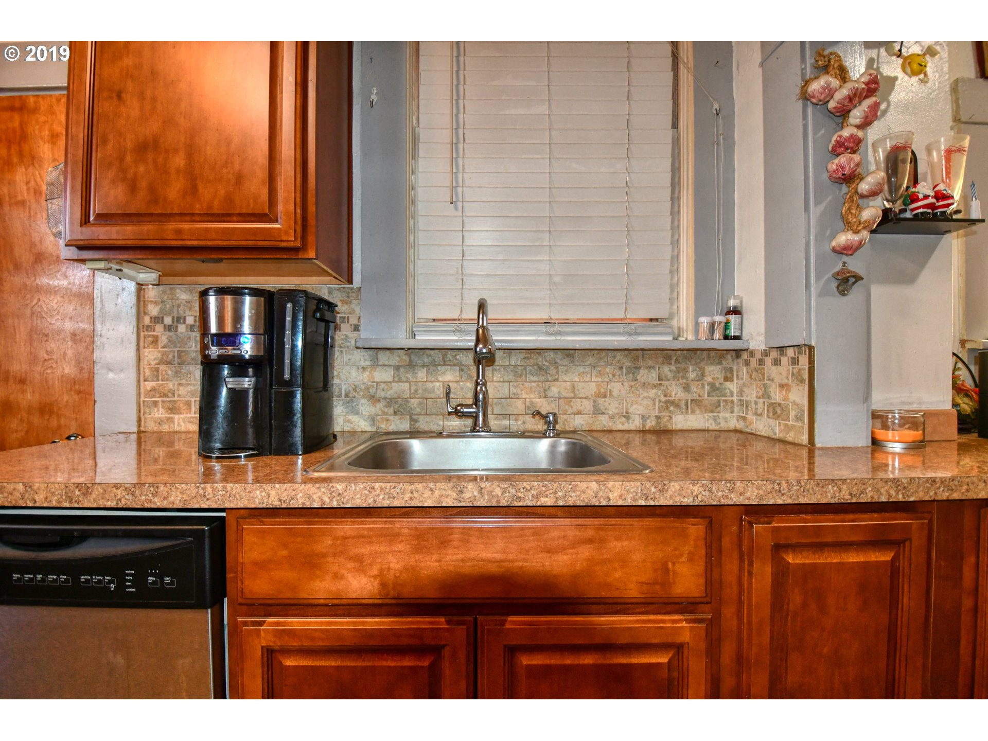 324 Southwest 2nd Street Pendleton, OR 97801 - Photo 16 of 32 a kitchen with granite countertop cabinets and black appliances