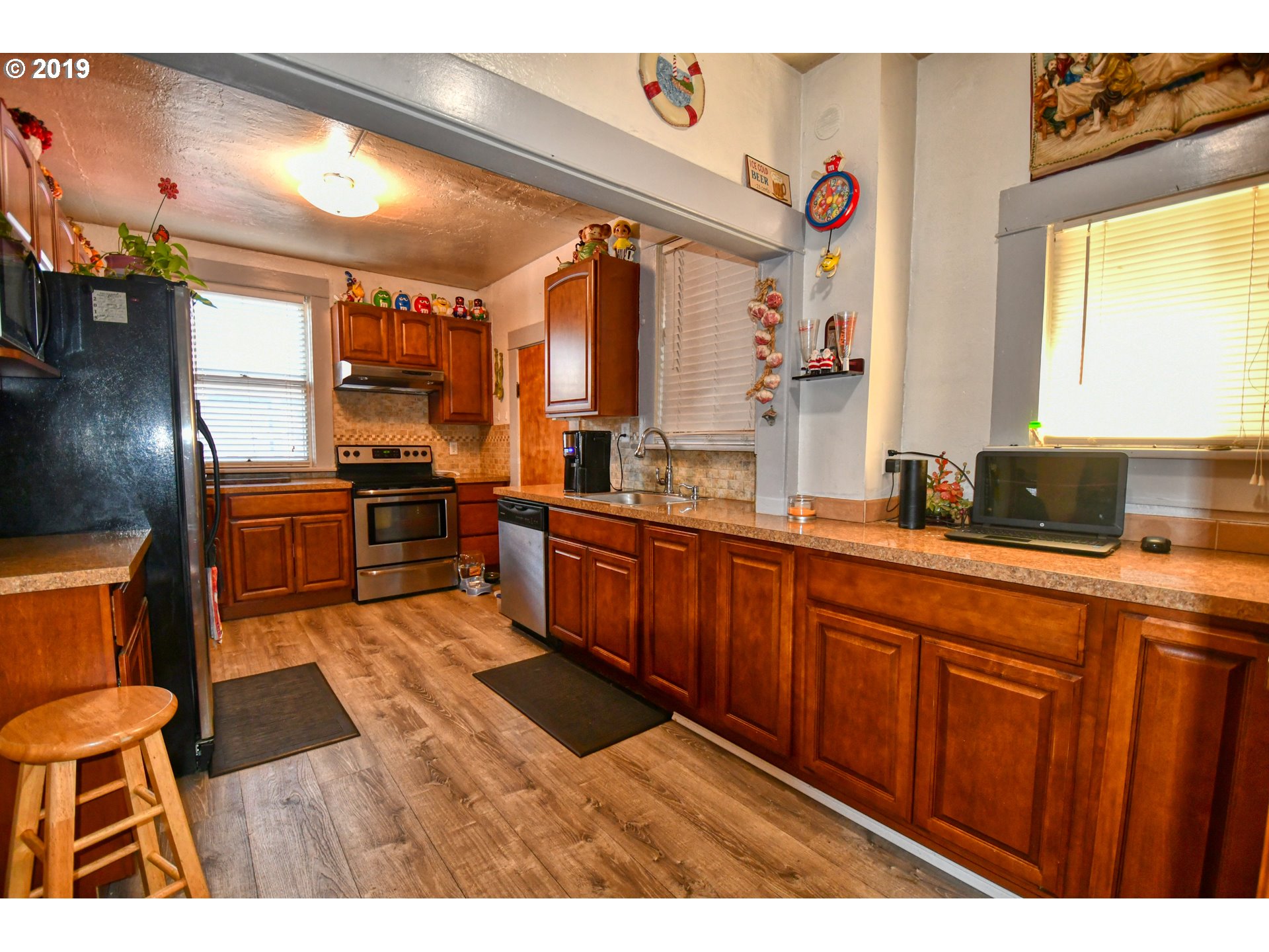 324 Southwest 2nd Street Pendleton, OR 97801 - Photo 10 of 32 a large kitchen with stainless steel appliances kitchen island granite countertop a sink and cabinets
