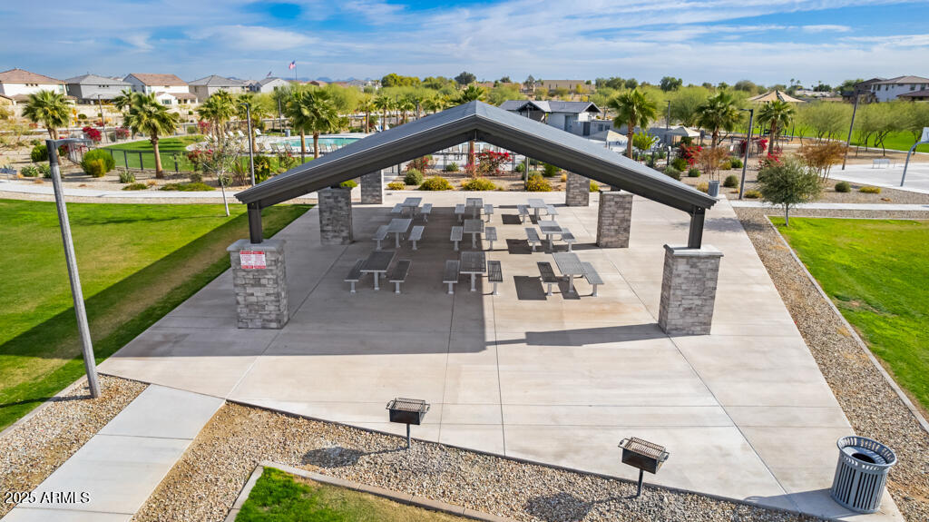 8875 West Colter Street Glendale, AZ 85305 - Photo 7 of 13 a view of a swimming pool with a patio and a garden