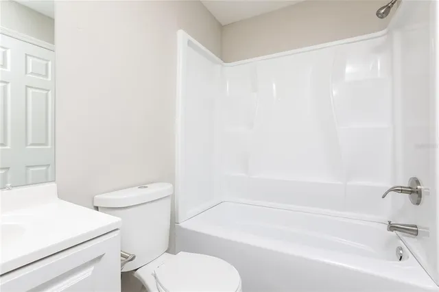 a bathroom with a toilet and a bathtub
