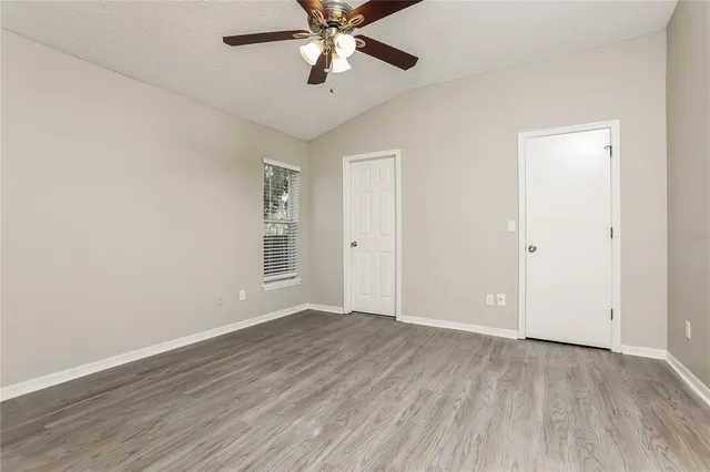 a view of an empty room with wooden floor