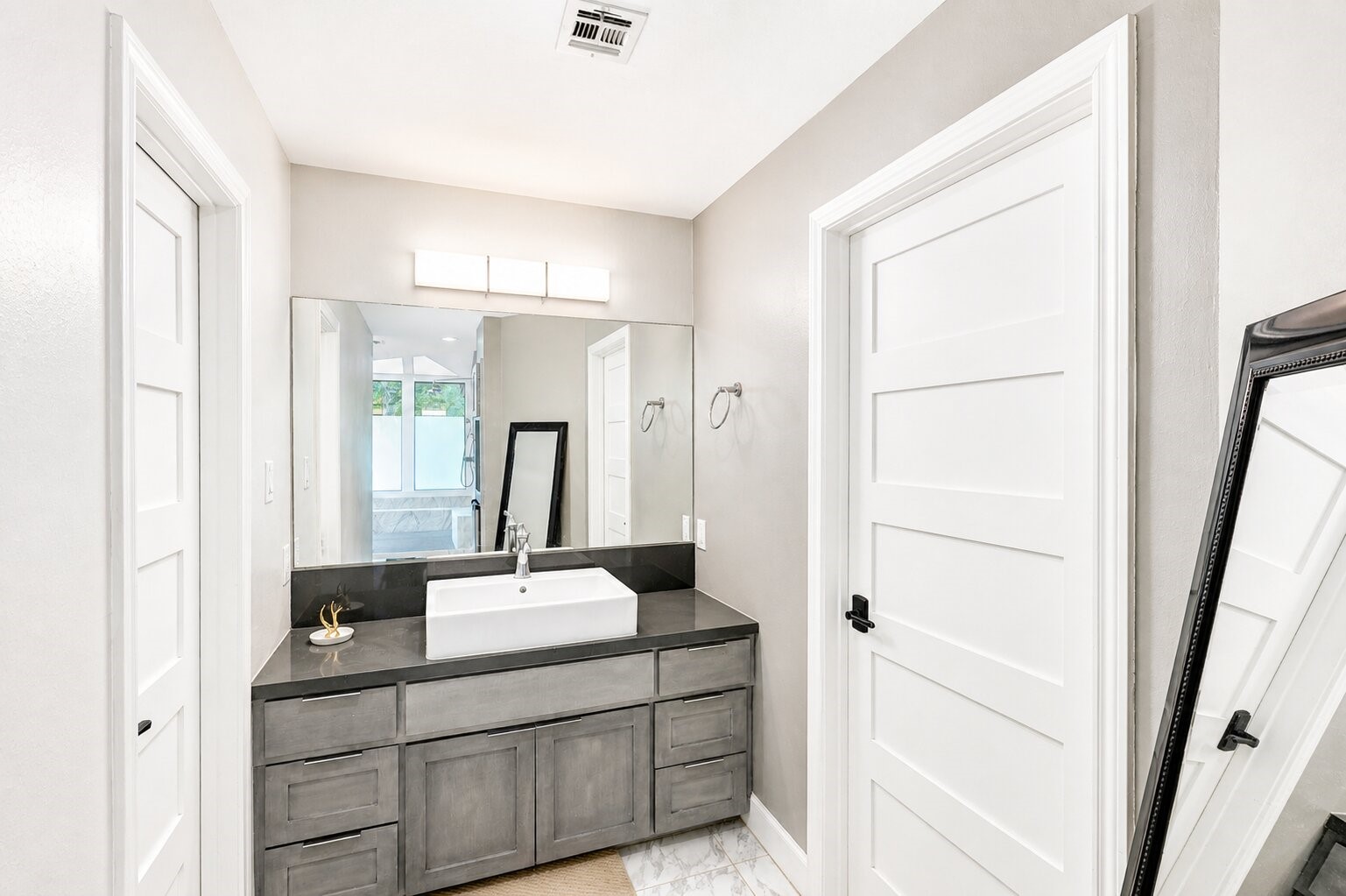 201 Vanderpool Lane, Unit 130 Houston, TX 77024 - Photo 28 of 41 The second of two vanity areas. The bathroom includes access to two large walk-in his/her closets. The water closet (to the right) includes another TOTO heated toilet and bidet.