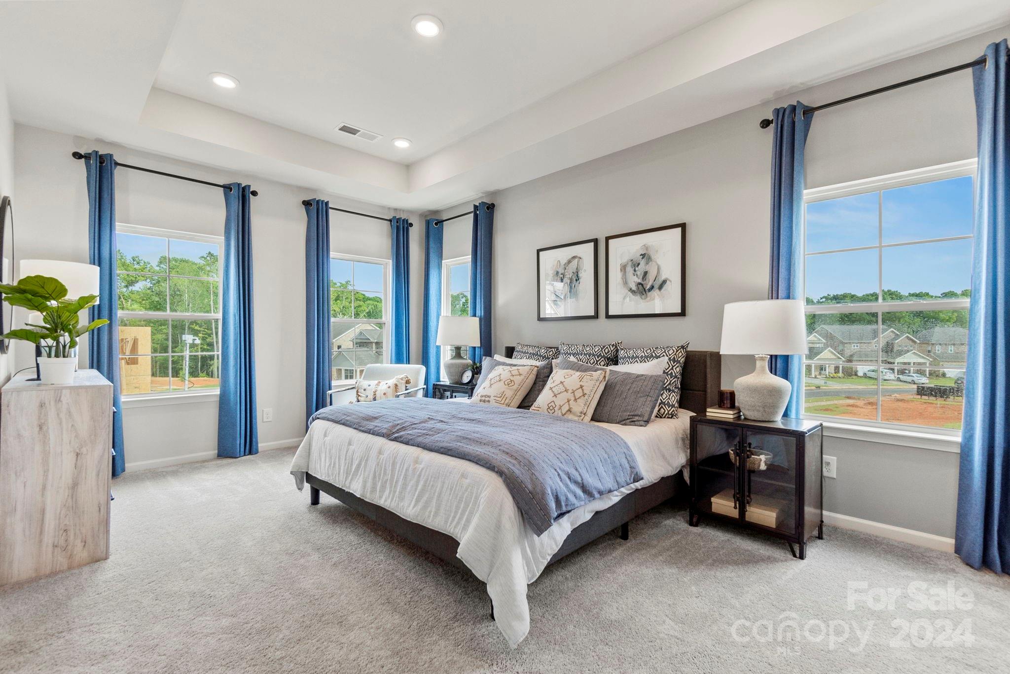 7906 Nelson Road Mint Hill, NC 28227 - Photo 11 of 29 a spacious bedroom with a large bed and a large window
