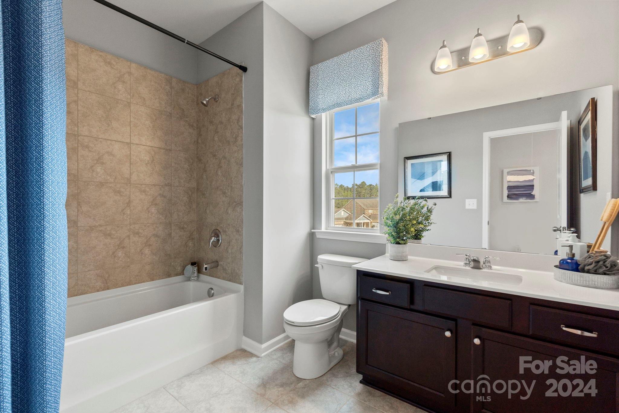 7906 Nelson Road Mint Hill, NC 28227 - Photo 17 of 29 a bathroom with a sink a toilet and shower