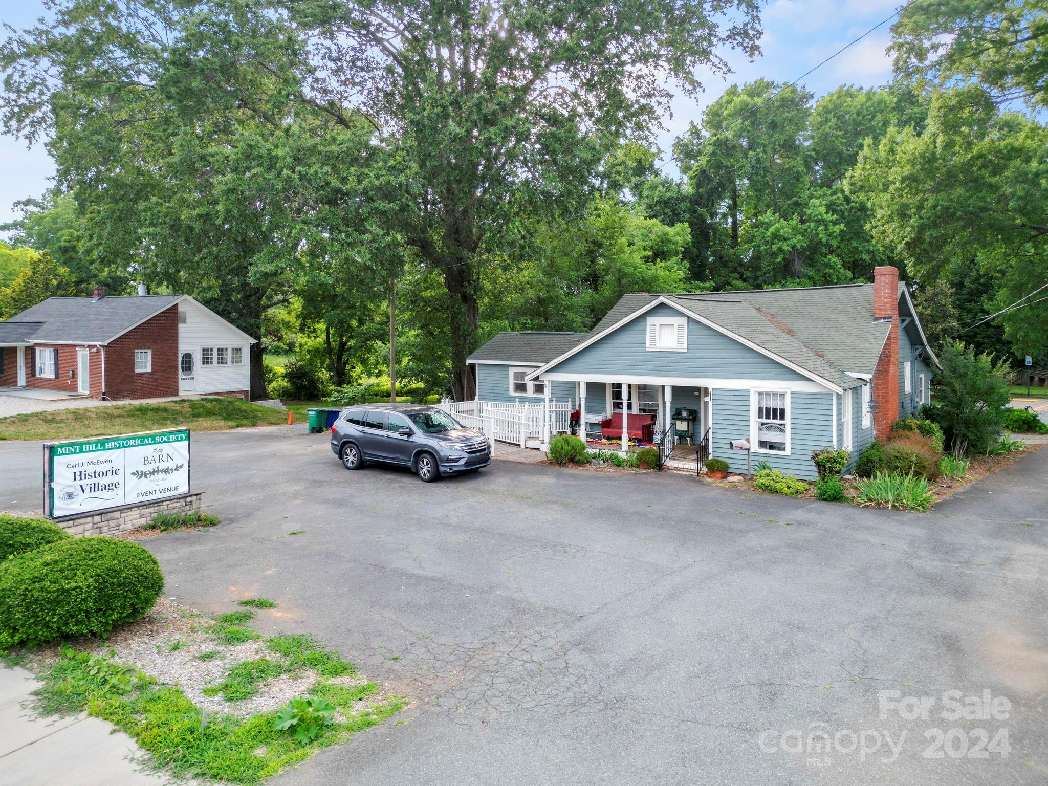 7906 Nelson Road Mint Hill, NC 28227 - Photo 22 of 29 a front view of a house with a garden and parking