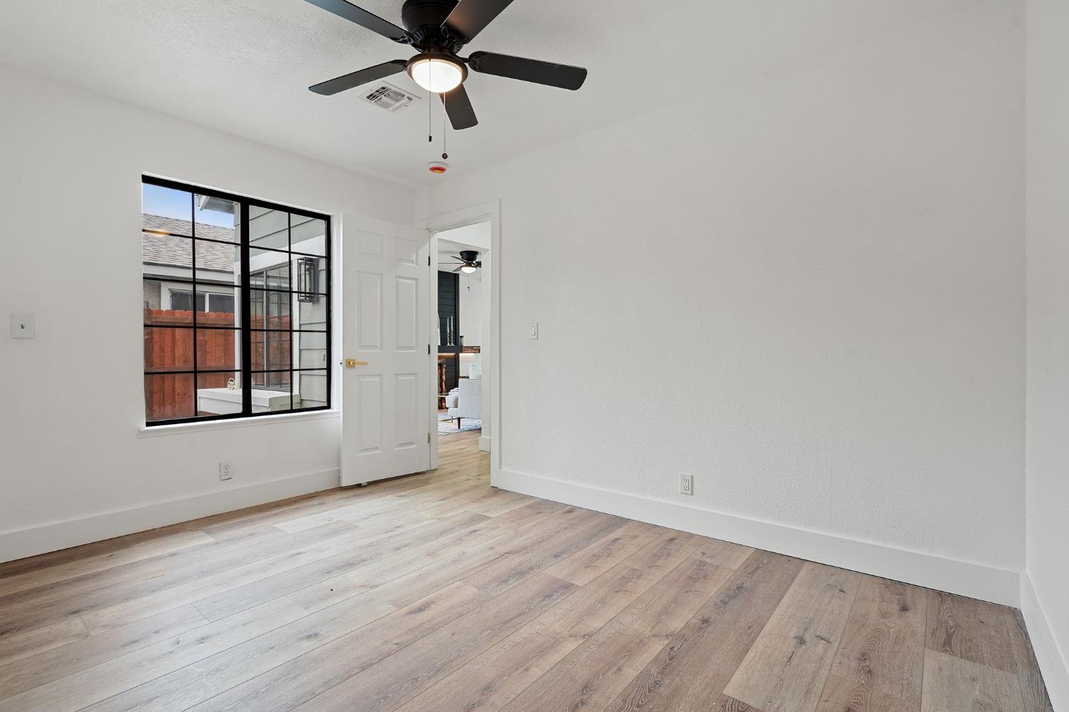 335 West Clover Road Tracy, CA 95376 - Photo 21 of 49 wooden floor in an empty room with a window