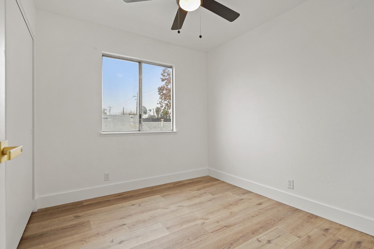 335 West Clover Road Tracy, CA 95376 - Photo 30 of 49 an empty room with a window and a ceiling fan