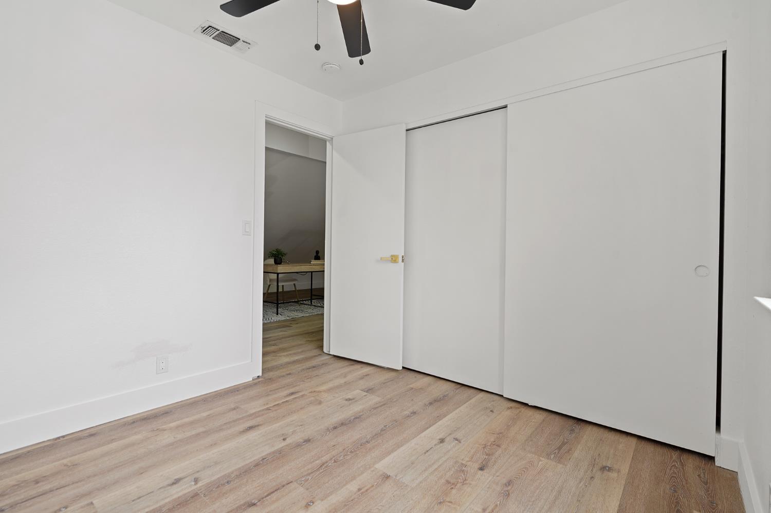 335 West Clover Road Tracy, CA 95376 - Photo 31 of 49 an empty room with wooden floor closet and windows