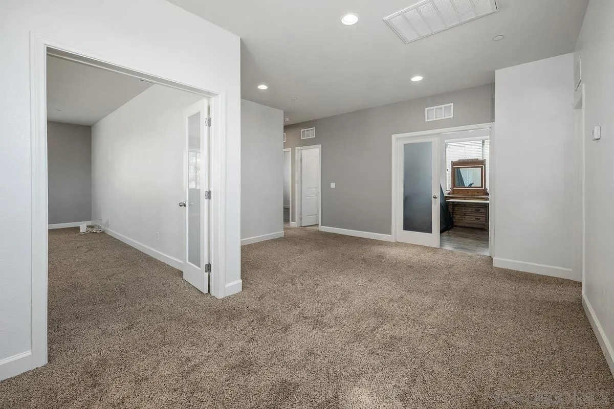 529 Adobe Estates Drive Vista, CA 92083 - Photo 25 of 39 an empty room with windows and closet