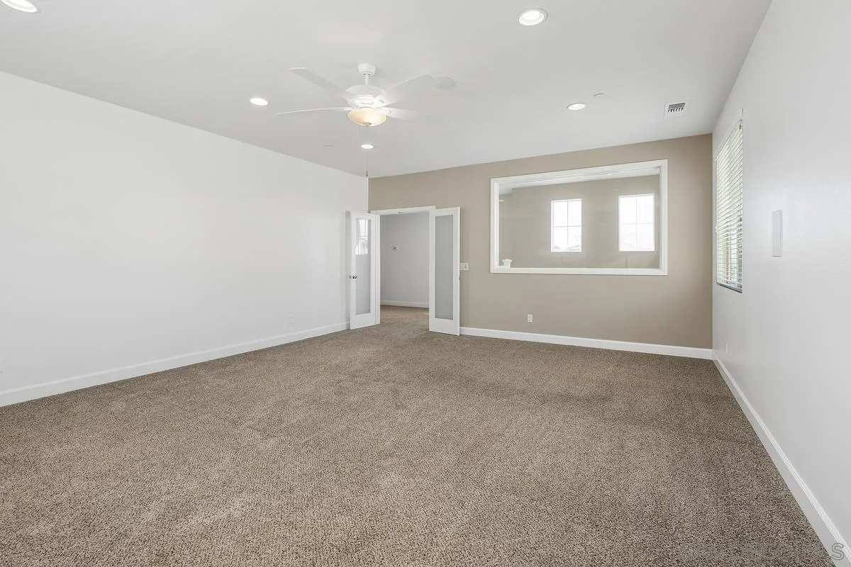 529 Adobe Estates Drive Vista, CA 92083 - Photo 27 of 39 an empty room with windows and closet