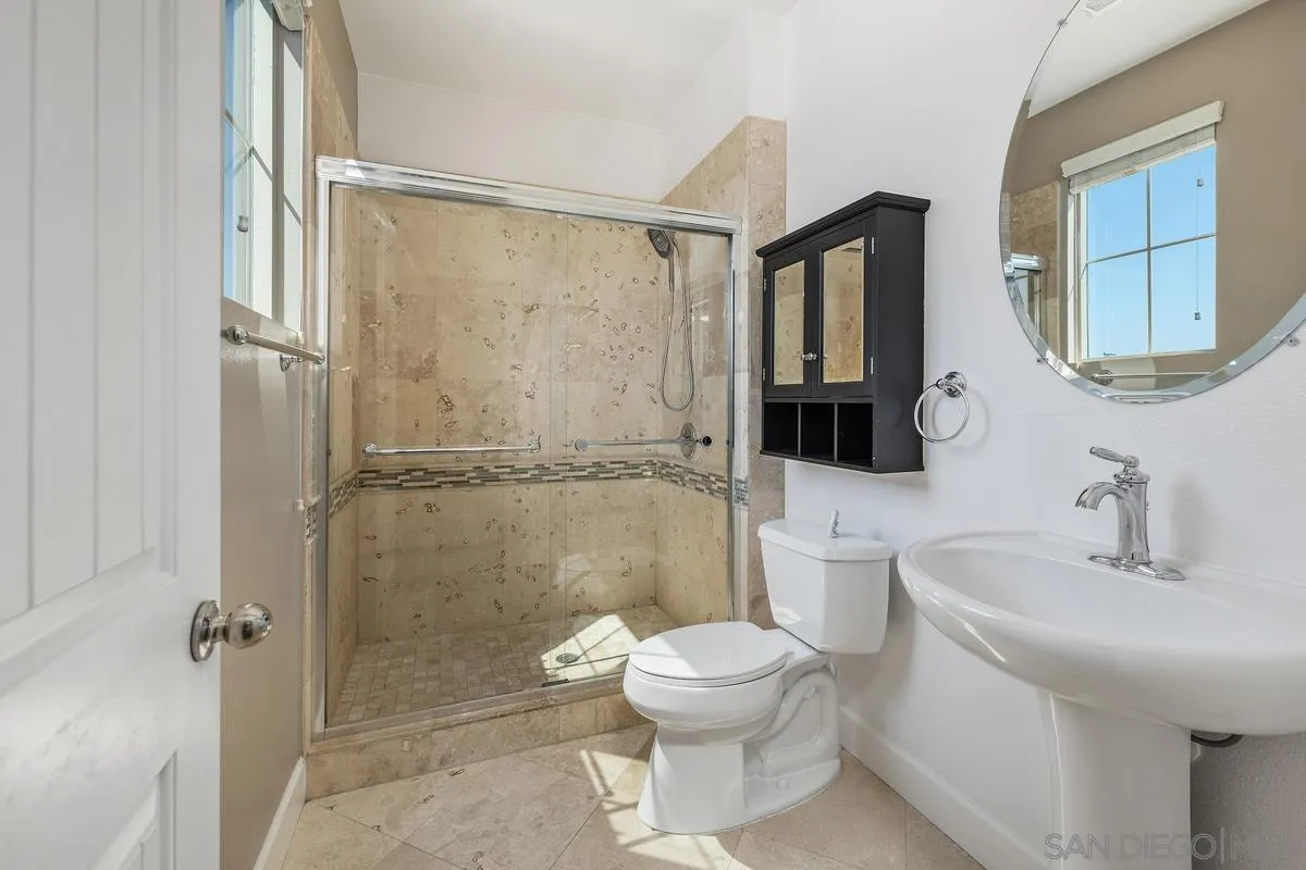 529 Adobe Estates Drive Vista, CA 92083 - Photo 30 of 39 a bathroom with a toilet a sink and shower