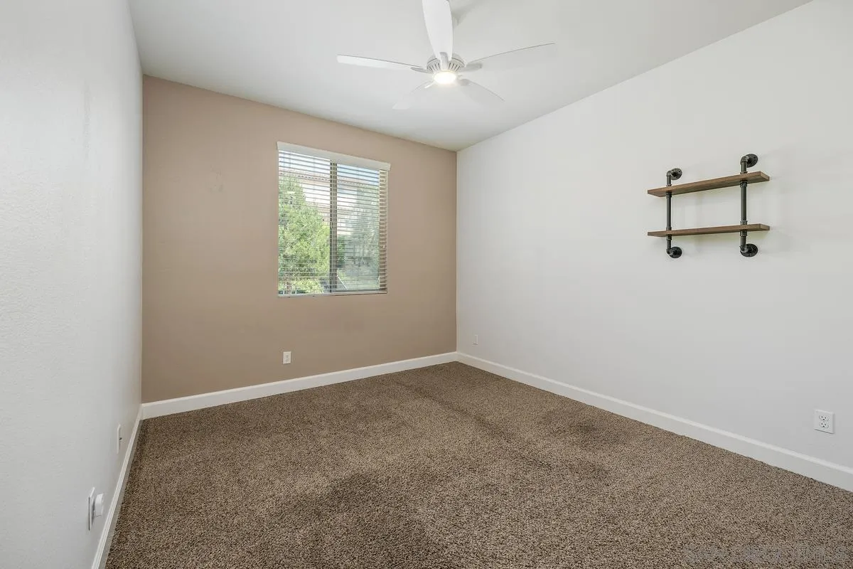 529 Adobe Estates Drive Vista, CA 92083 - Photo 32 of 39 an empty room with windows and fan