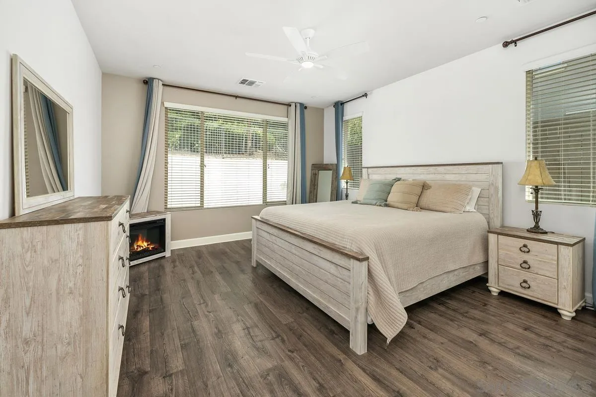 529 Adobe Estates Drive Vista, CA 92083 - Photo 9 of 39 a bedroom with a bed and a flat tv screen on the dresser