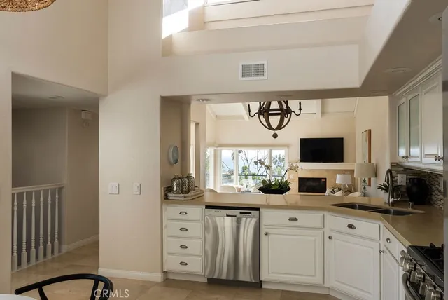 a kitchen with granite countertop a table chairs stove and refrigerator