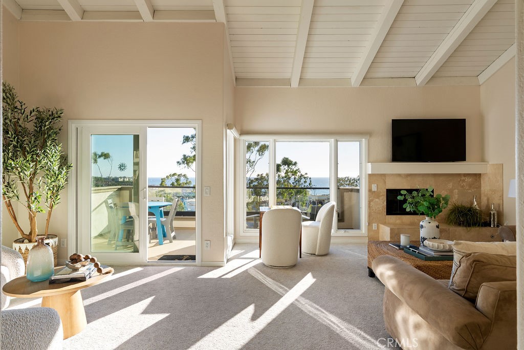 23274 Atlantis Way Dana Point, CA 92629 - Photo 15 of 53 a living room with furniture a fireplace and a flat screen tv