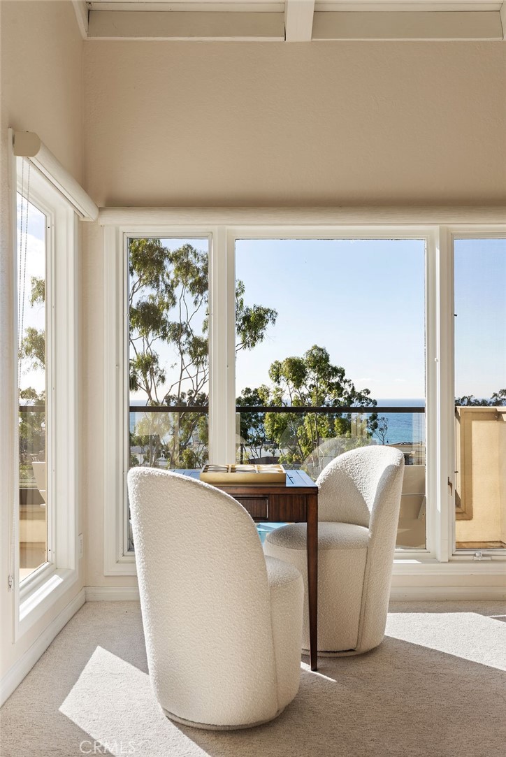 23274 Atlantis Way Dana Point, CA 92629 - Photo 21 of 53 a living room with furniture and a floor to ceiling window