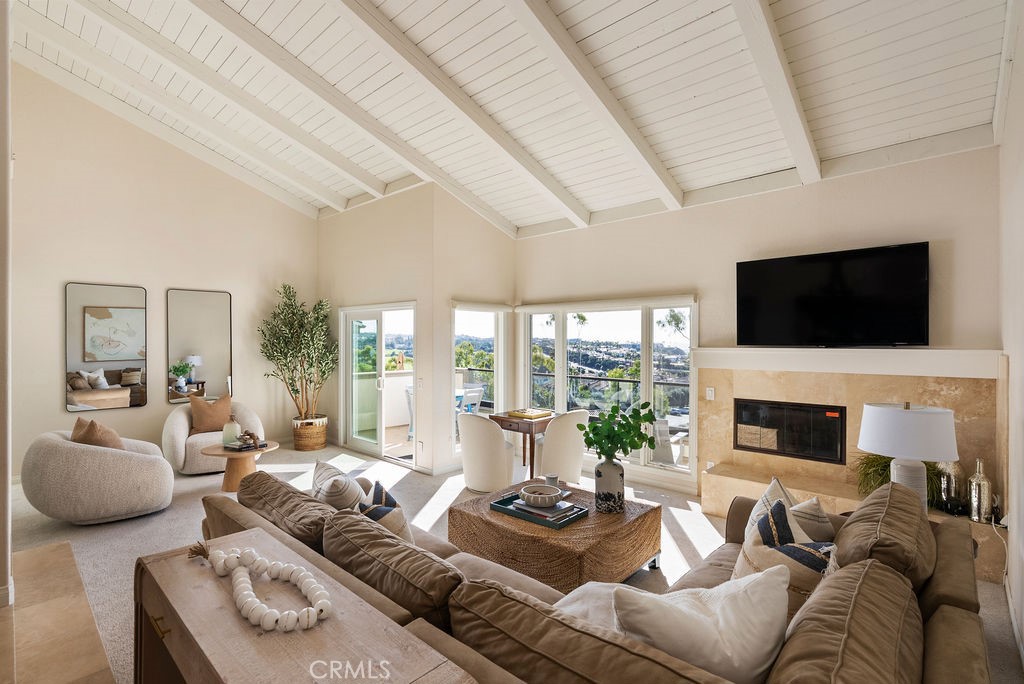 23274 Atlantis Way Dana Point, CA 92629 - Photo 24 of 53 a living room with furniture fireplace and a flat screen tv