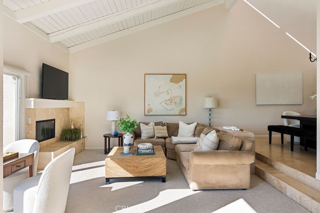 23274 Atlantis Way Dana Point, CA 92629 - Photo 28 of 53 a living room with furniture a fireplace and a flat screen tv