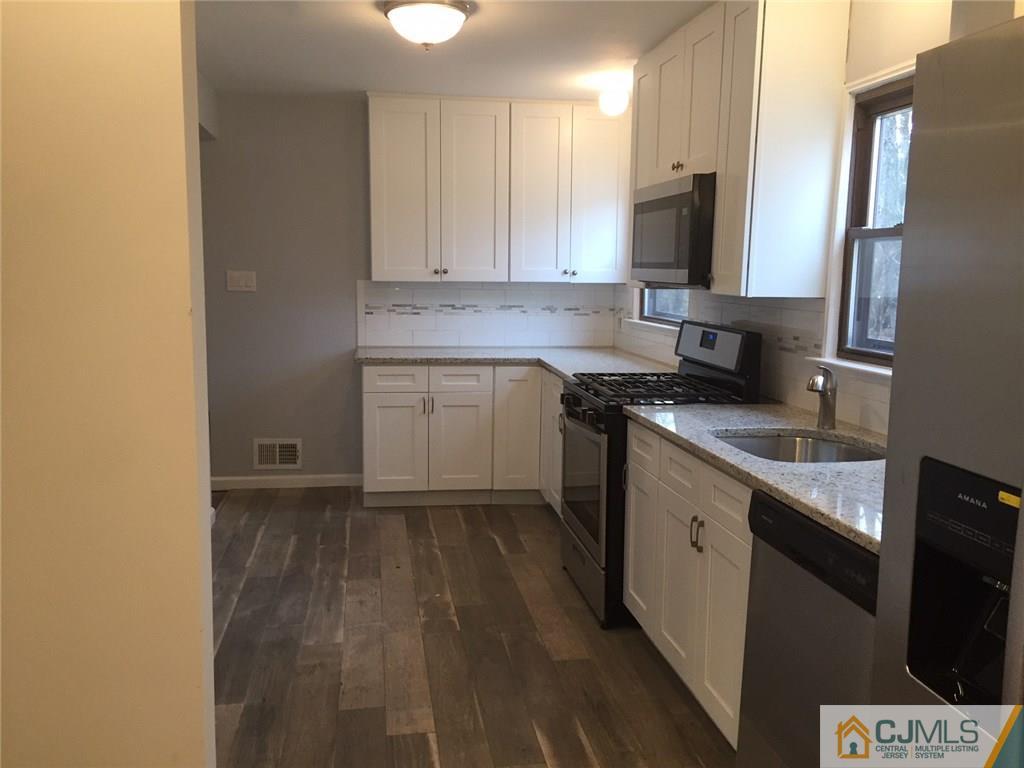 24 Sine Road Edison, NJ 08817 - Photo 2 of 11 a kitchen with a sink stove and refrigerator