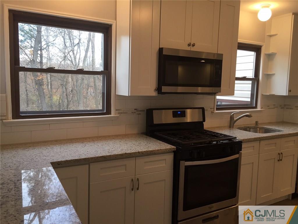 24 Sine Road Edison, NJ 08817 - Photo 3 of 11 a kitchen with a stove and a microwave