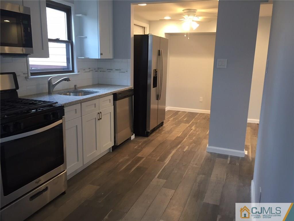 24 Sine Road Edison, NJ 08817 - Photo 4 of 11 a kitchen with granite countertop a sink and a stove top oven