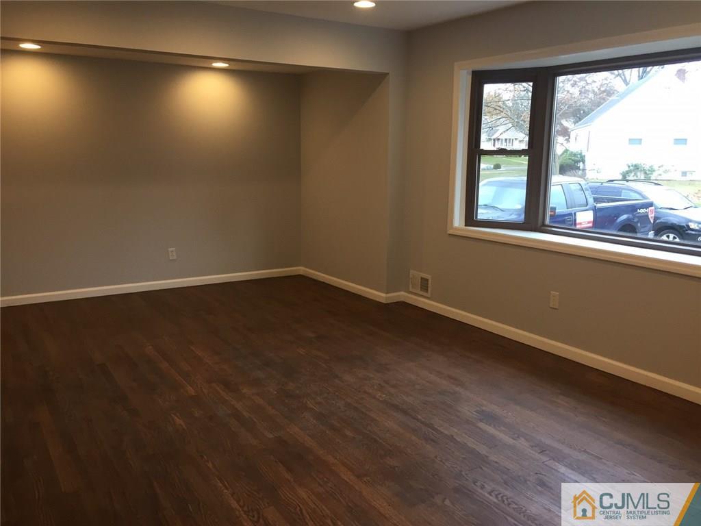 24 Sine Road Edison, NJ 08817 - Photo 5 of 11 an empty room with wooden floor and windows