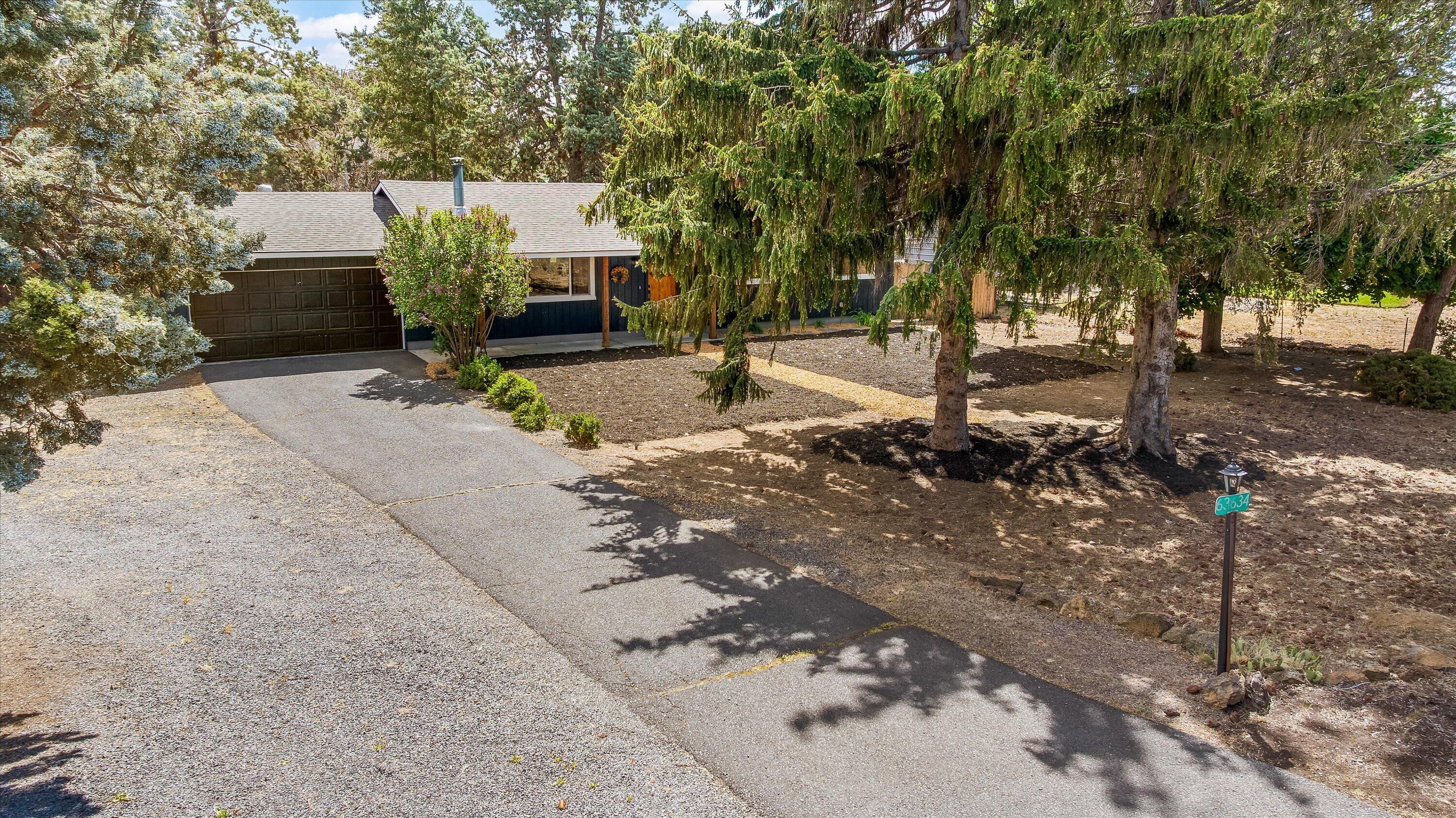 63634 Hunters Circle Bend, OR 97701 - Photo 24 of 28 a front view of a house with a yard