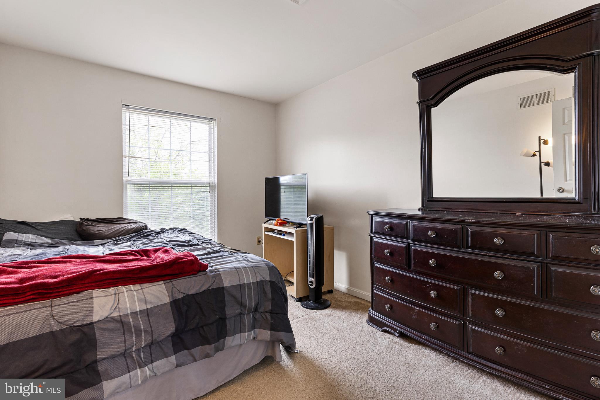 16 Highland Circle Newark, DE 19713 - Photo 16 of 20 a bedroom with a bed and a mirror on dresser